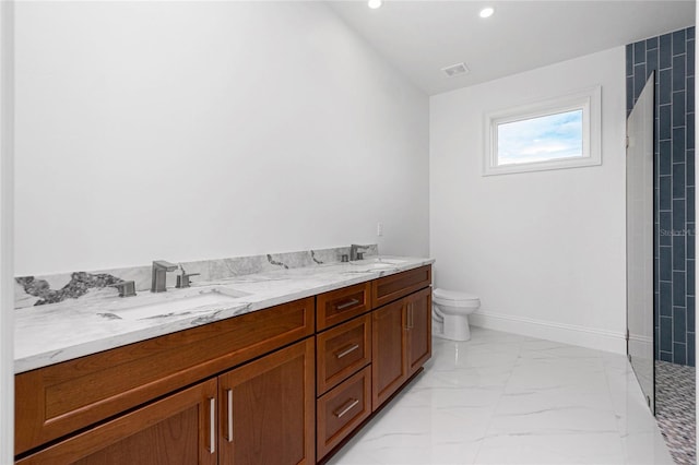 bathroom featuring vanity, a tile shower, and toilet