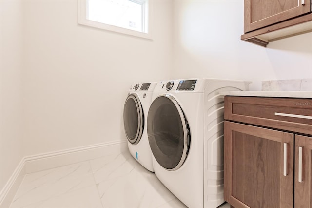 laundry area featuring cabinets and washer and dryer