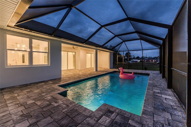 view of pool with a lanai, a patio, and ceiling fan