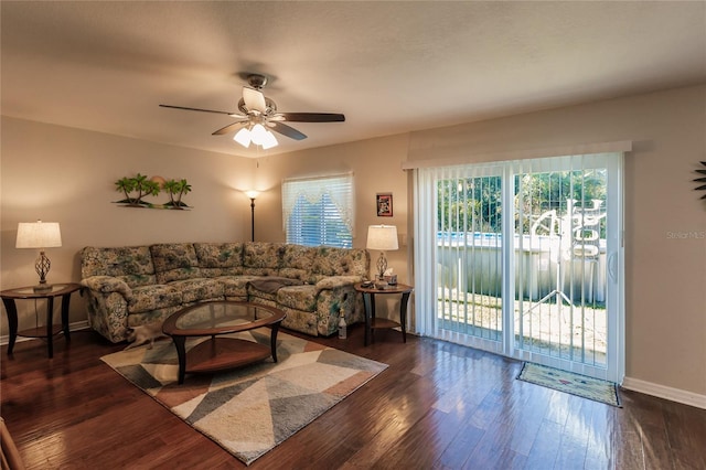 living room with ceiling fan and dark hardwood / wood-style floors