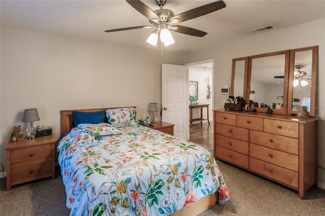 bedroom featuring dark carpet and ceiling fan