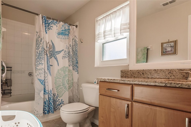 full bathroom with shower / bath combo with shower curtain, tile patterned flooring, vanity, and toilet