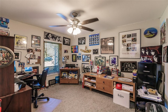 carpeted home office featuring ceiling fan