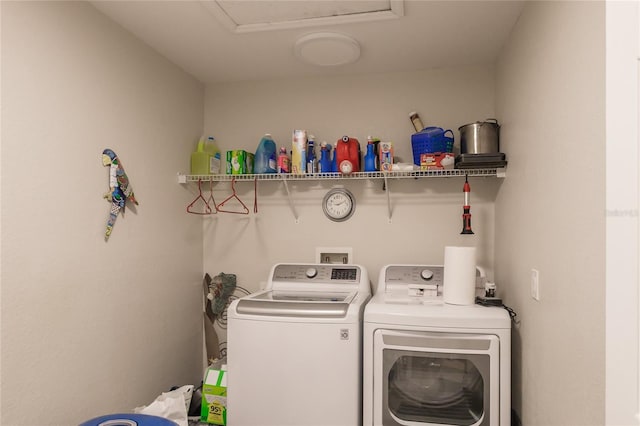 clothes washing area featuring washer and clothes dryer