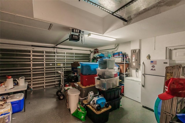 garage featuring electric panel, white fridge, a garage door opener, and fridge