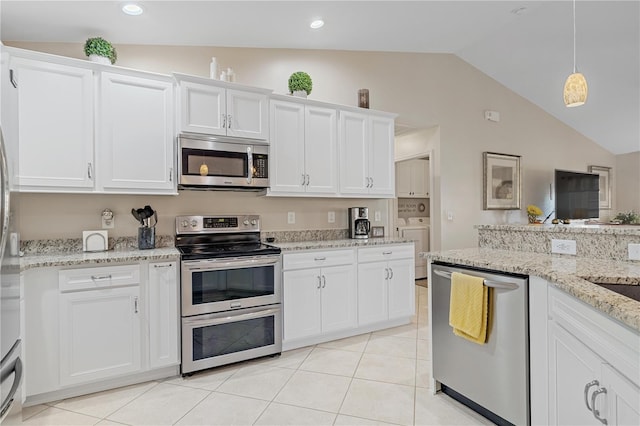 kitchen featuring washing machine and clothes dryer, white cabinets, stainless steel appliances, and vaulted ceiling