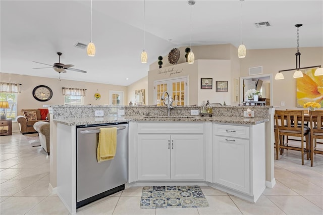 kitchen featuring white cabinets, dishwasher, hanging light fixtures, and vaulted ceiling