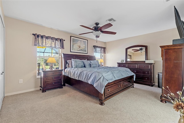 bedroom with light carpet, a closet, multiple windows, and ceiling fan