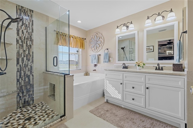 bathroom with tile patterned floors, separate shower and tub, and vanity