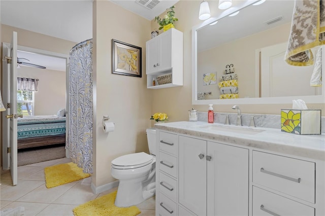 bathroom with tile patterned flooring, vanity, and toilet