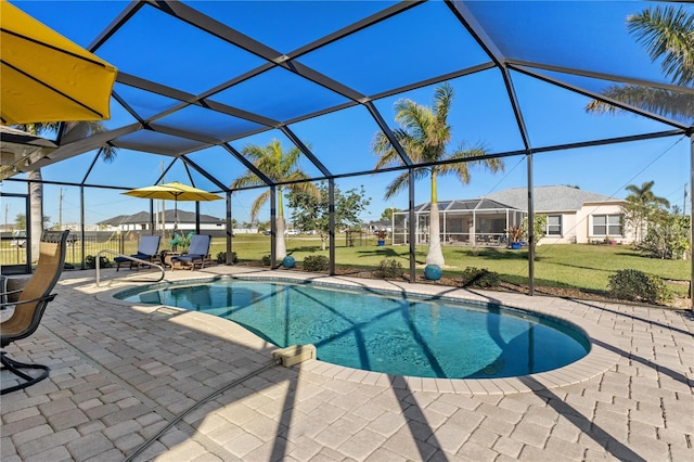 view of pool featuring a yard, a patio area, and a lanai