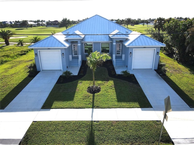 view of front facade with a front yard and a garage