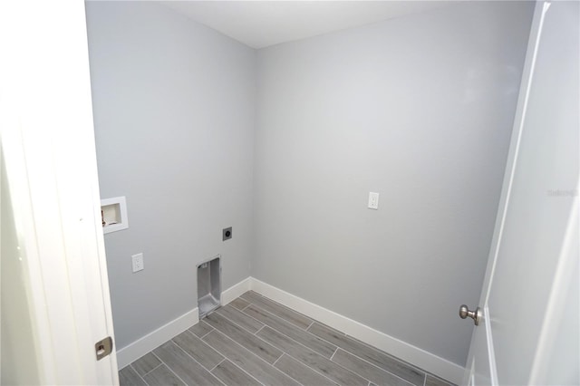 laundry area with electric dryer hookup, hookup for a washing machine, and hardwood / wood-style floors