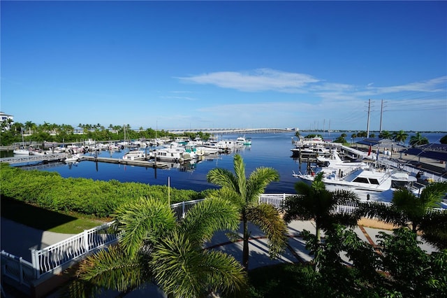 water view with a dock and fence