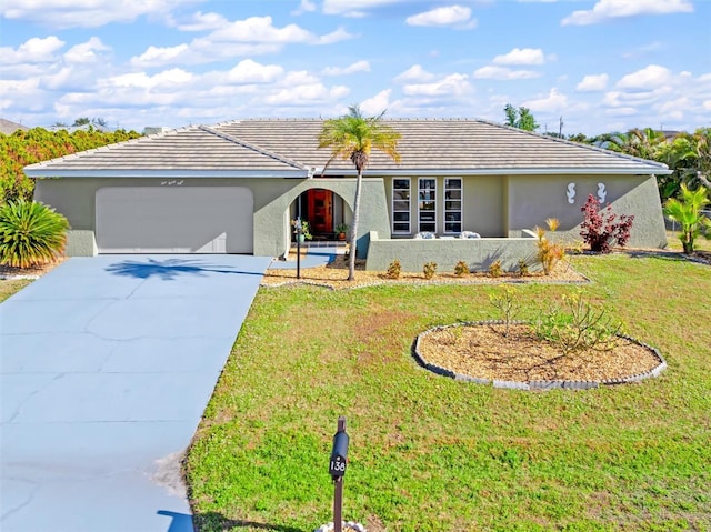 ranch-style home featuring a garage and a front yard