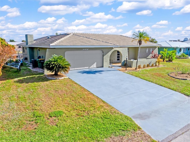 ranch-style home featuring a garage and a front lawn