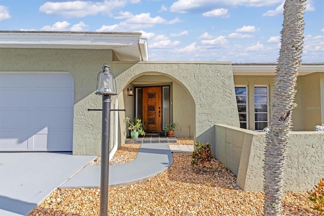 view of exterior entry with a garage