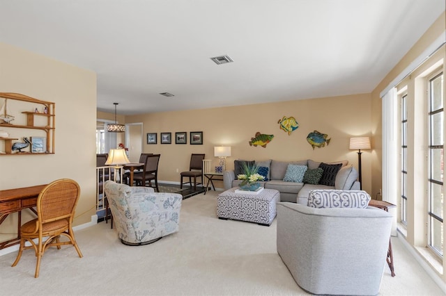 living room with light carpet and a wealth of natural light