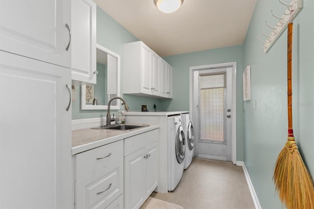 washroom featuring sink, cabinets, and washer and dryer