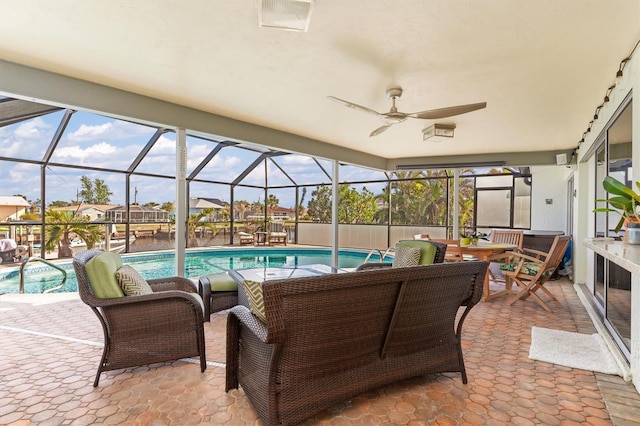 view of patio featuring a lanai, an outdoor hangout area, and ceiling fan