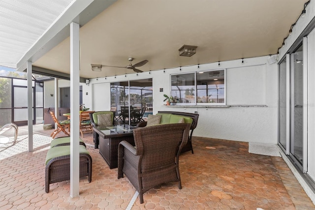 sunroom featuring ceiling fan