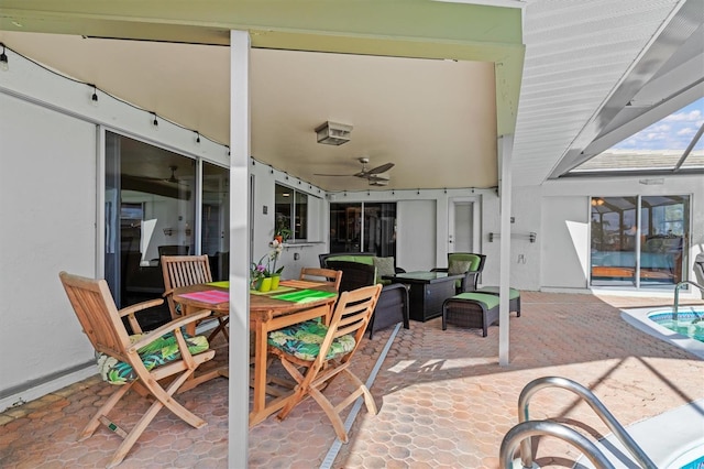 view of patio / terrace with ceiling fan and glass enclosure