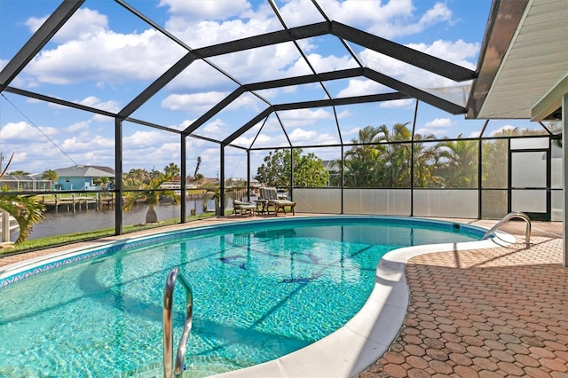 view of swimming pool featuring a patio, glass enclosure, and a water view