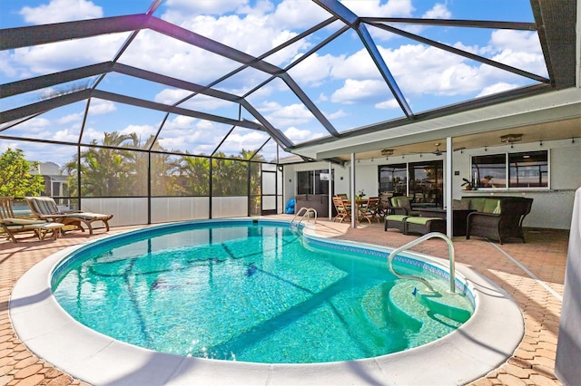 view of swimming pool with a lanai and a patio area