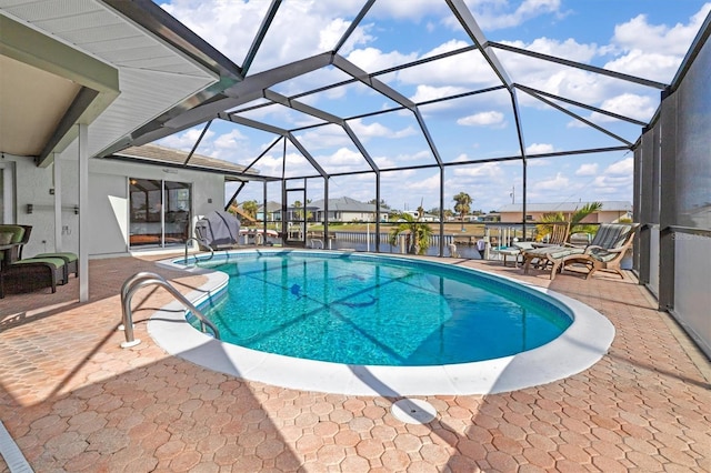 view of swimming pool featuring a lanai and a patio area