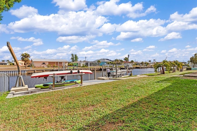 dock area with a water view and a lawn