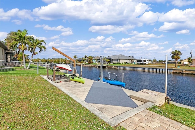 dock area with a water view and a yard