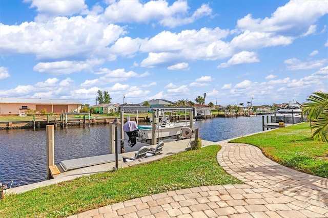 view of dock with a yard and a water view