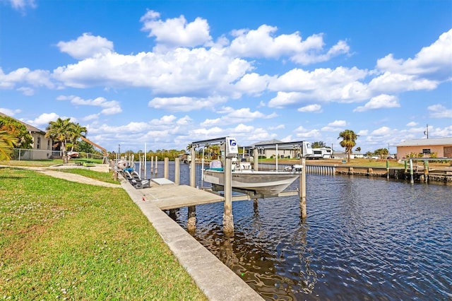 view of dock featuring a water view and a yard