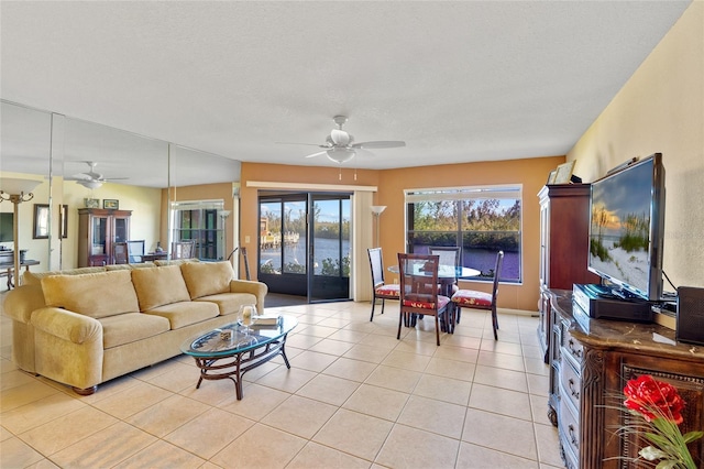 living room featuring ceiling fan and light tile patterned flooring