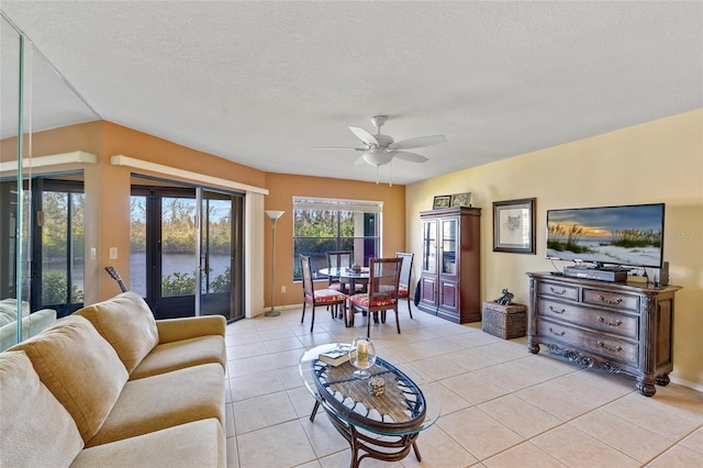 tiled living room with french doors, a textured ceiling, vaulted ceiling, and ceiling fan