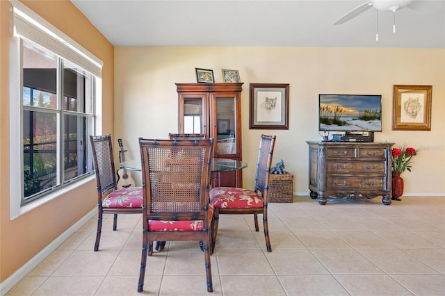 tiled dining space featuring ceiling fan