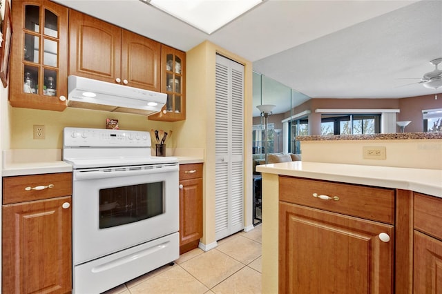 kitchen with hanging light fixtures, electric range, ceiling fan, and light tile patterned flooring