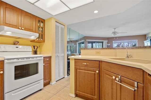 kitchen featuring light tile patterned floors, sink, ceiling fan, and electric stove