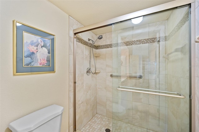 bathroom with toilet and walk in shower