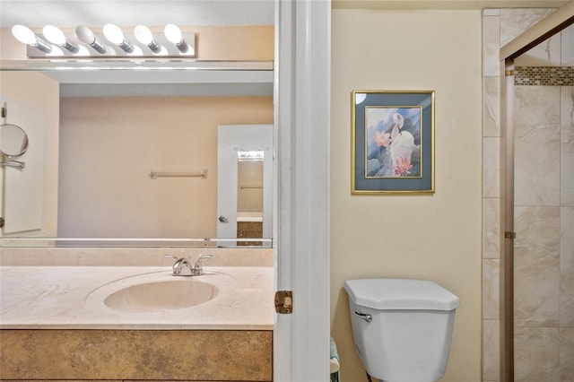 bathroom with vanity, a shower with shower door, and toilet