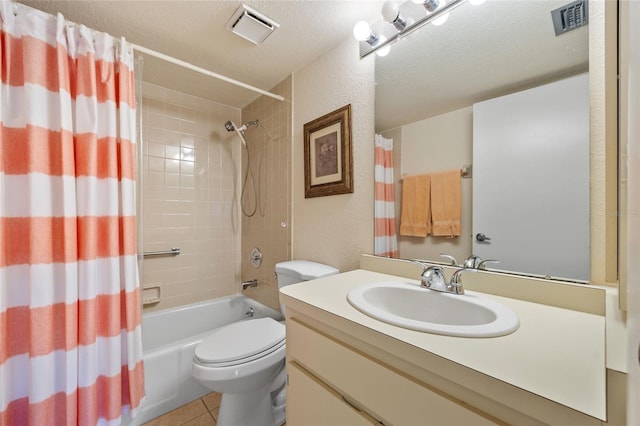 full bathroom featuring vanity, tile patterned flooring, toilet, shower / bath combo with shower curtain, and a textured ceiling