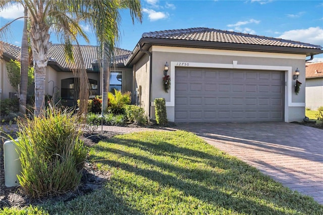 view of front facade with a front yard and a garage