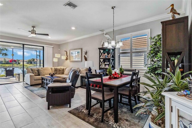 tiled dining area with ceiling fan with notable chandelier and ornamental molding