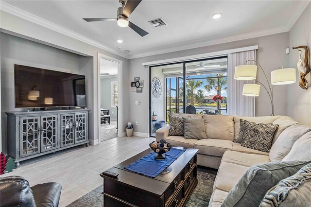 living room with hardwood / wood-style flooring, ceiling fan, and crown molding