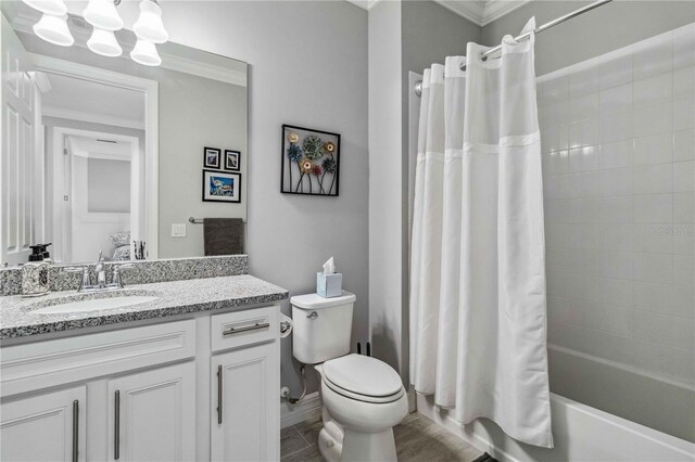 full bathroom with shower / bath combo, vanity, toilet, and crown molding