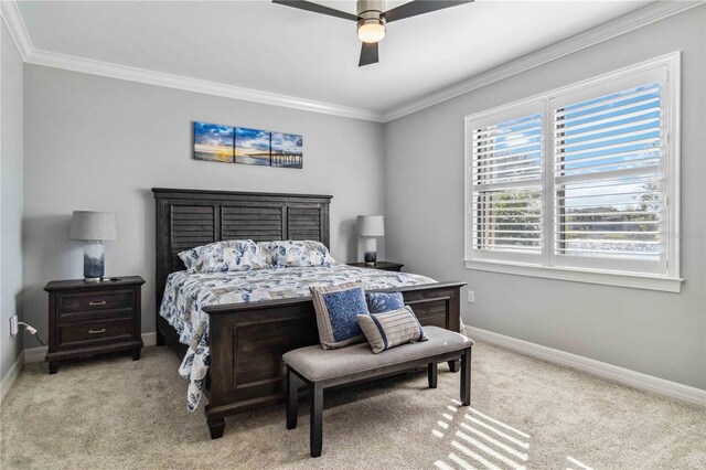 carpeted bedroom with ceiling fan and ornamental molding