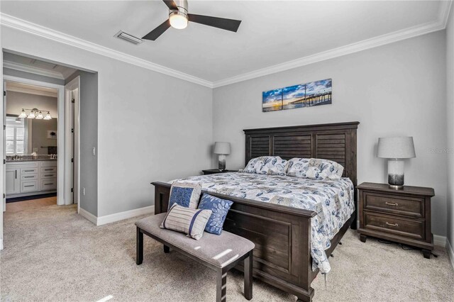 bedroom featuring ceiling fan, light colored carpet, ornamental molding, and ensuite bathroom