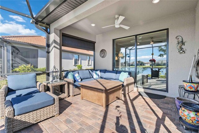 view of patio / terrace featuring outdoor lounge area, a water view, and ceiling fan