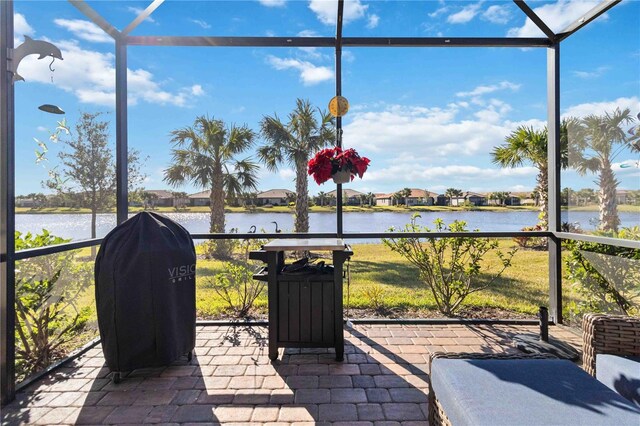 unfurnished sunroom featuring a water view