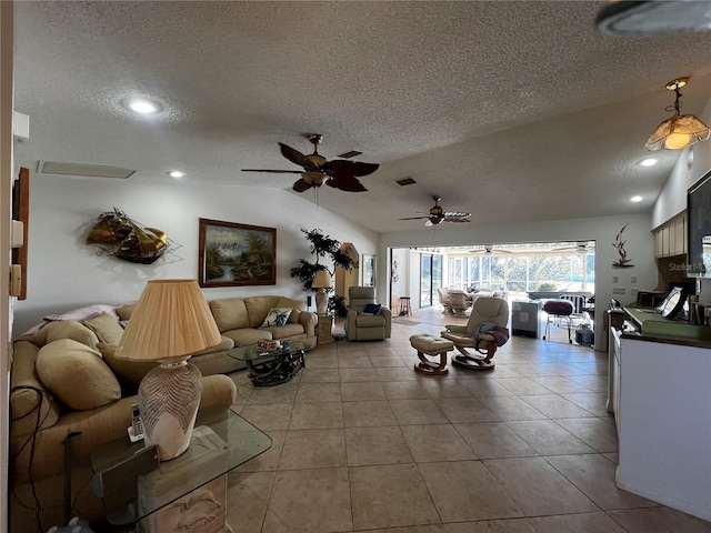 tiled living room with a textured ceiling, ceiling fan, and vaulted ceiling